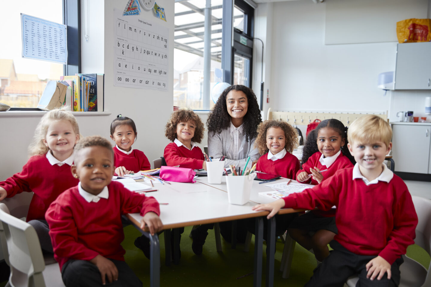 portrait of infant school teacher and kids sitting 2024 10 22 13 10 07 utc