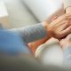 Psychiatrist hands holding palm of patient